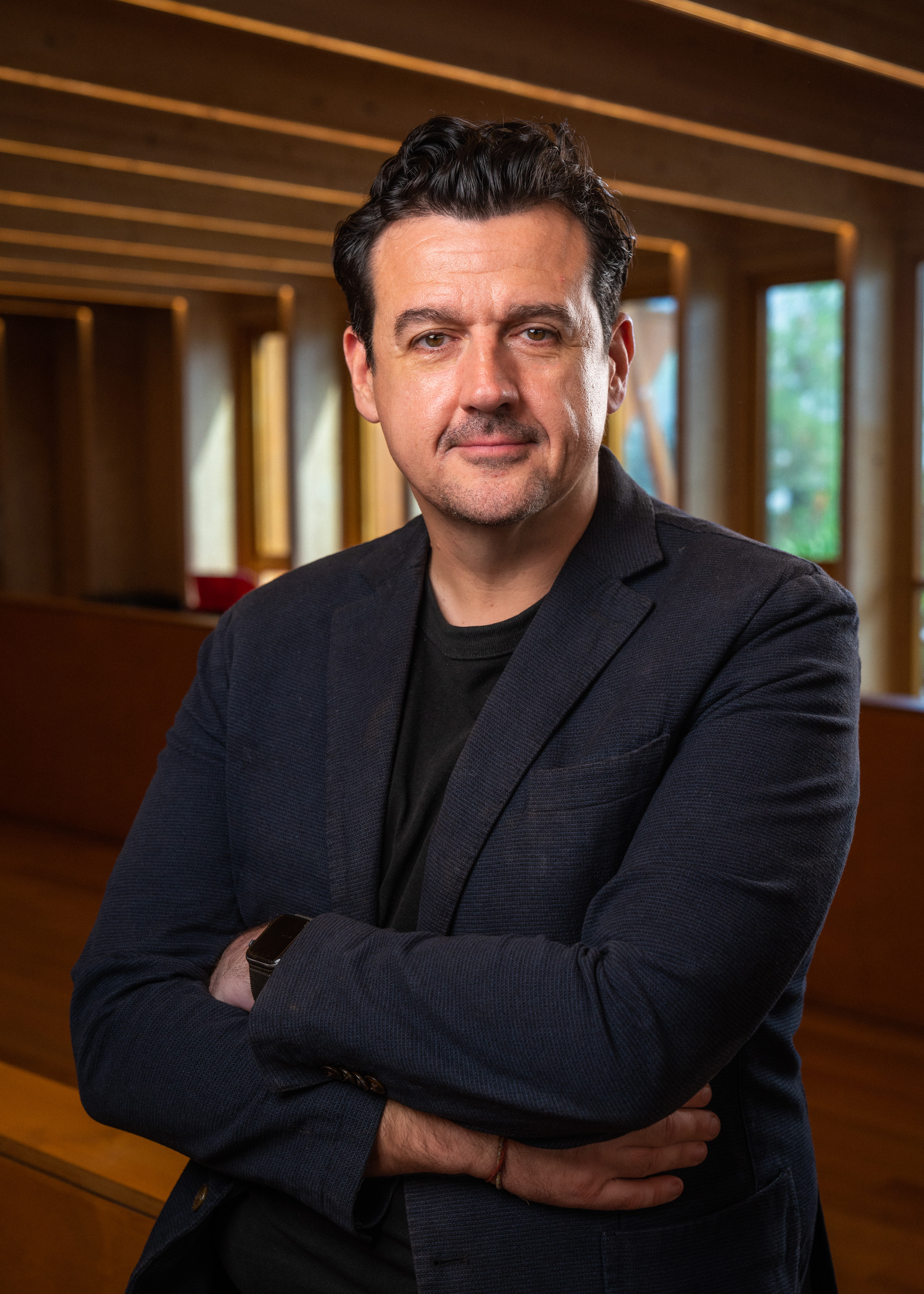 Portrait of Sam Moran in a dark blazer