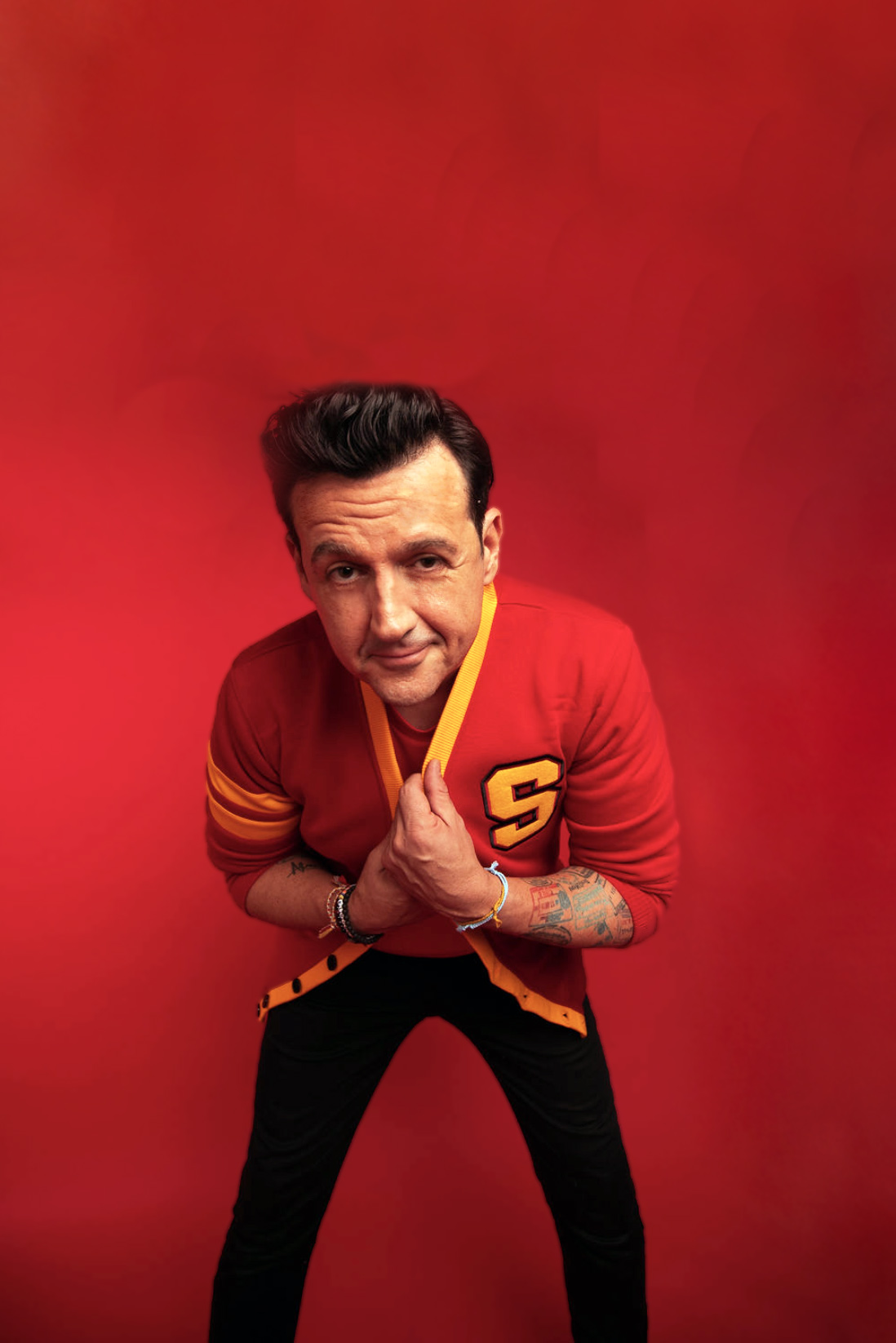 Sam Moran in a vivid red studio portrait